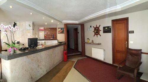 a kitchen with a counter and a bar in a room at Hotel La Ronda in Castro-Urdiales