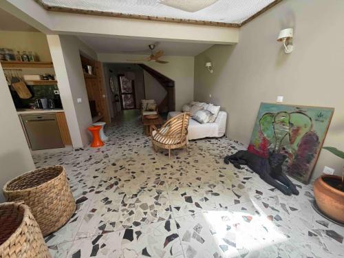 una sala de estar con un sofá y sillas en Villa GEORGETTE - Saint Gilles 50 M du lagon, en Saint-Paul