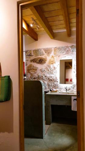 a kitchen with a sink and a stone wall at El Diablo y La Luna B&B by El Diablo y La Sandia in Oaxaca City