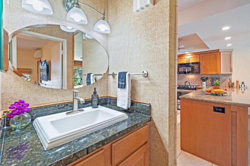 a bathroom with a sink and a mirror at Kahana Sunset B4B in Lahaina