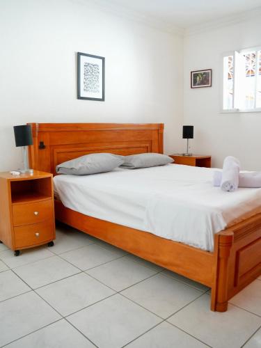 En eller flere senge i et værelse på Férias a 5 min da praia | Piscina | Churrasqueira