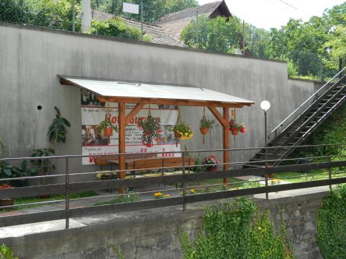 a bus stop with a bench next to a wall at Casa Anette in Sovata