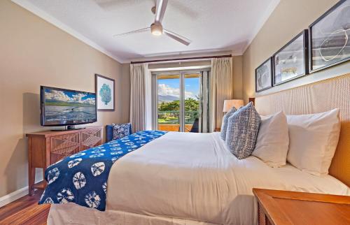 a bedroom with a bed and a tv and a window at Honua Kai Konea 206 in Lahaina