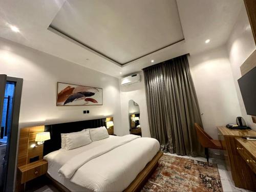 a bedroom with a large white bed in a room at Bricks Residence in Lekki