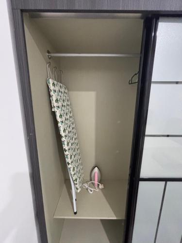 a walk in closet with a shelf with a knife at Princeton Suite @Kuching Airport in Kuching