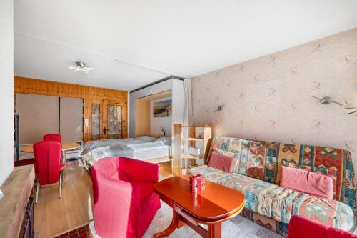 a living room with a couch and a table at Les Bouleaux D1 - 2-4 pers - centre station in Nendaz