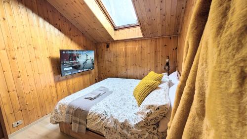 a bedroom with a bed in a wooden room at Apartments in the woods in Pila