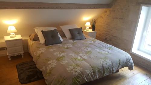 sypialnia z dużym łóżkiem z 2 lampami w obiekcie Maisoun Pequeux w mieście Arromanches-les-Bains