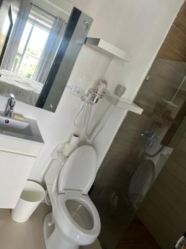 a bathroom with a toilet and a sink and a shower at Perfecto para 3 personas. in Boca Chica