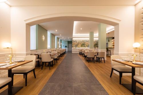 a large dining room with tables and chairs at Stella Braga Aparthotel in Braga