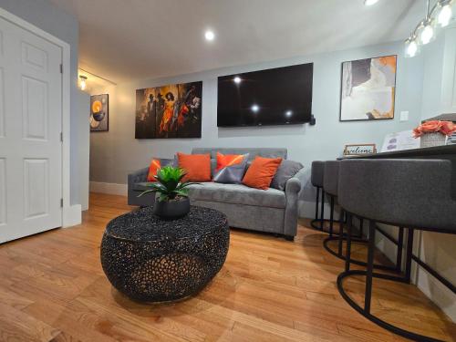 a living room with a couch and a table at Brand New 2BR House 20Min Downtown Boston in Boston