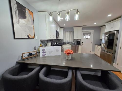 a kitchen with a large table with chairs around it at Brand New 2BR House 20Min Downtown Boston in Boston