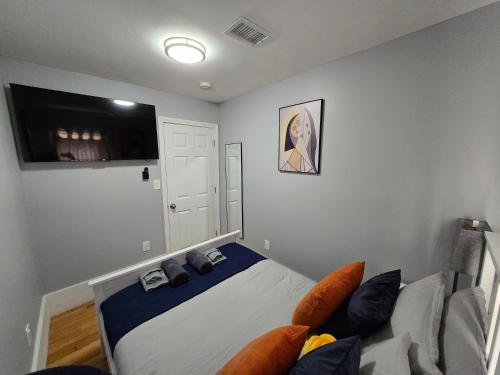 a bedroom with a bed and a couch at Brand New 2BR House 20Min Downtown Boston in Boston