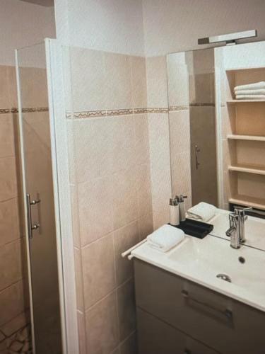 a bathroom with a sink and a shower with a mirror at Stunning seasides retreat in Bora Bora