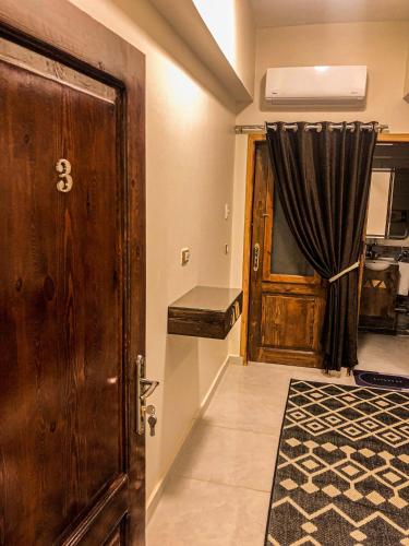 a room with a door and a window with a curtain at Sharty Hotel in Abu Simbel