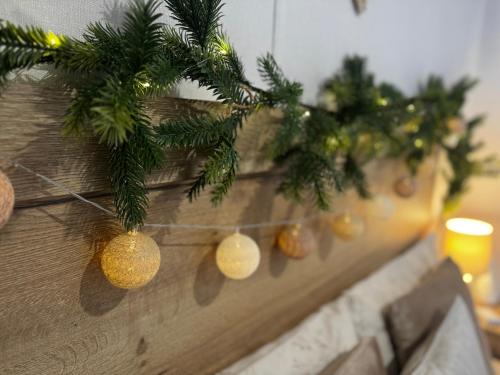 a row of christmas decorations on a wooden fence at Big Boss Caravan-Camber Sands,Sleep 8, Free Wi-Fi, Netflix, Parking in Camber