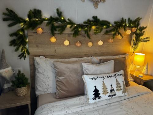 a bedroom with a bed with christmas decorations on it at Big Boss Caravan-Camber Sands,Sleep 8, Free Wi-Fi, Netflix, Parking in Camber