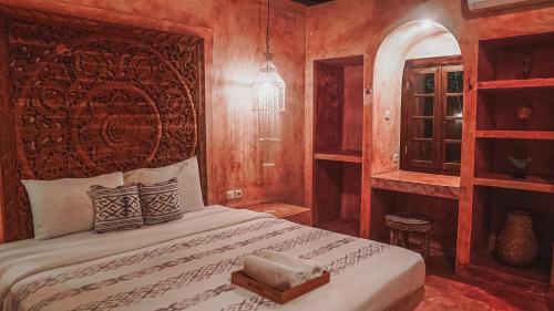 a bedroom with a large bed with a wooden wall at Adara Homestay in Banyuwangi