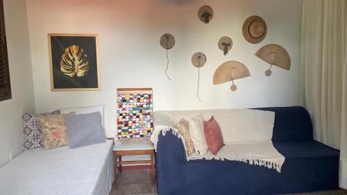 a living room with a couch and umbrellas on the wall at ACM Flat in Natal
