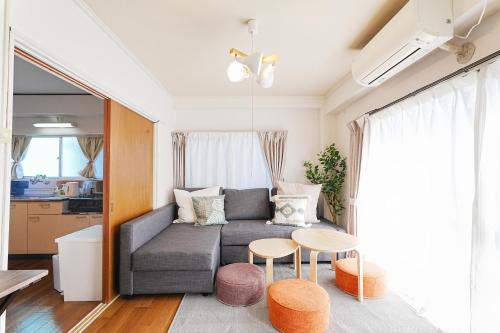 a living room with a couch and a table at Tomo House Yoyogi 301 - from 4 minutes station 代々木 301 駅から徒歩4分 in Tokyo