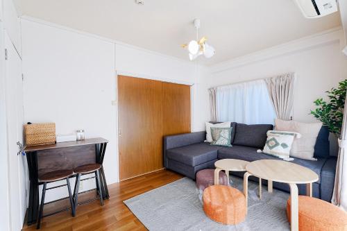 a living room with a couch and a table at Tomo House Yoyogi 301 - from 4 minutes station 代々木 301 駅から徒歩4分 in Tokyo