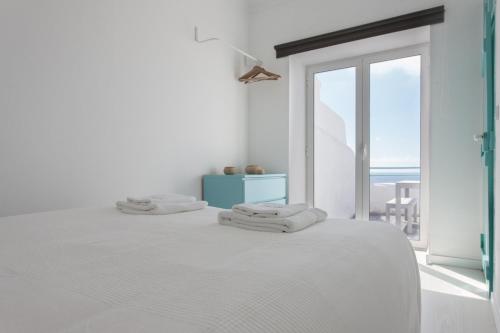エリセイラにあるFLH Ericeira Ocean Flatの白いベッドルーム(窓付きのベッド付)