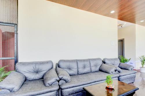 una sala de estar con un sofá y una mesa en Hotel O SRINIVASA RESIDENCY, en Pedda Ambarpet