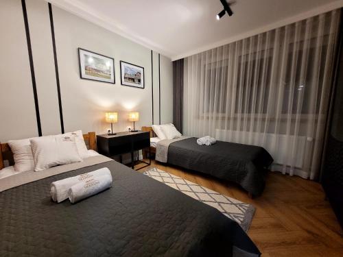 En eller flere senge i et værelse på Apartament Skansen - Sanok