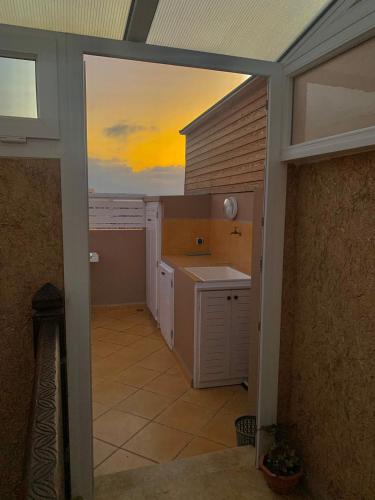 a view of a kitchen with a sunset in the background at Appartement terrasse de la mer in Mirleft