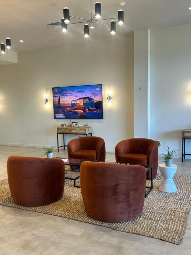 a waiting room with brown leather chairs and a rug at Downtown Detroit Studio Apt in Detroit