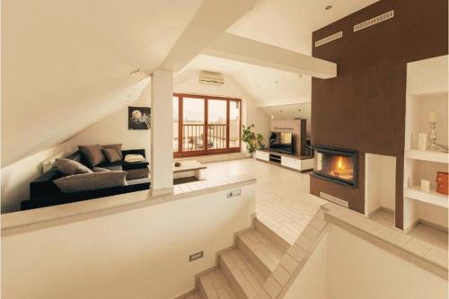 a living room with a couch and a fireplace at Apartment Mountain Sunrise in Škofja Loka