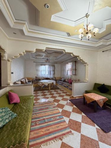 a large living room with couches and a checkered floor at Samadis Home in Larache