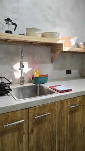 a kitchen counter with a sink and a bowl at Lagalag Studios in El Nido