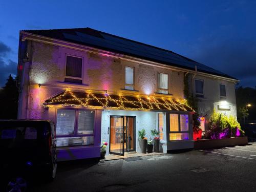 a building with christmas lights on the side of it at The Gatwick White House Hotel in Horley
