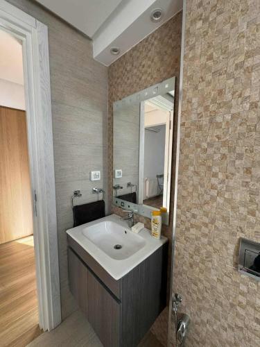 a bathroom with a sink and a mirror at New Sweet Home Soukra in Sukrah