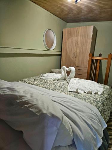 a bedroom with two swans sitting on a bed at Elysium House in Salamina