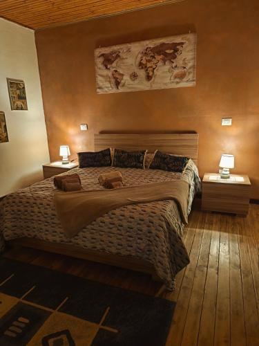 a bedroom with a large bed with two night stands at Nel blu dipinto di blu in Malesco