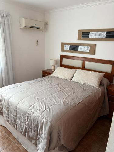 a bedroom with a bed and two tables and a window at Fenix 2 in Colón