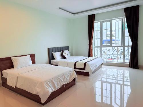 Ένα ή περισσότερα κρεβάτια σε δωμάτιο στο Vienna Hotel