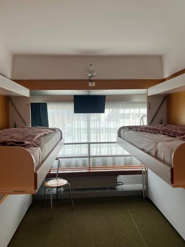 two bunk beds in a room with a window at Casa Chiara Marilleva 1400 in Marilleva