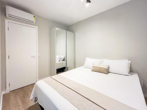 圣劳伦斯海滨Riviera | Excelente Novo com Enxoval Completo的卧室配有一张白色大床和一个衣柜