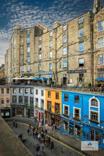 a group of people walking in front of a building at 2Bedroom apartment by the castle in Edinburgh