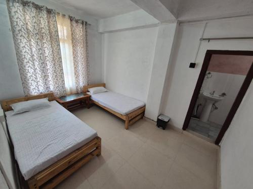 Postel nebo postele na pokoji v ubytování Hornbill Homes 1