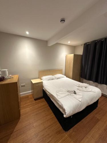 a bedroom with a large white bed in it at Cavendish Annexe in High Wycombe