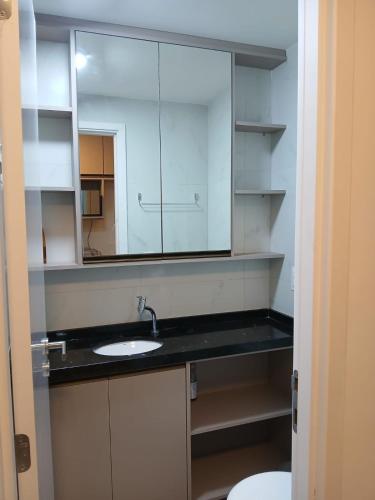 a bathroom with a sink and a mirror at Porto City - Flat 06 com Jacuzzi in Porto De Galinhas