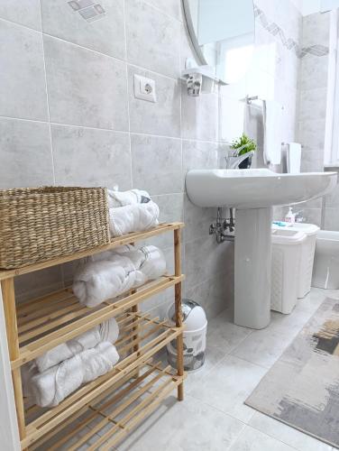 a bathroom with a sink and a toilet and towels at Pignola Maison in Pignola