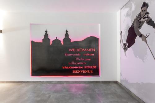 a large poster on a wall in a room at Hubertus Logis Apartments in Brixen im Thale