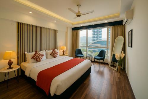 a hotel room with a bed and a large window at Bella Hotel Apartments- Executive Stay Opposite Centaurus Mall Islamabad in Islamabad