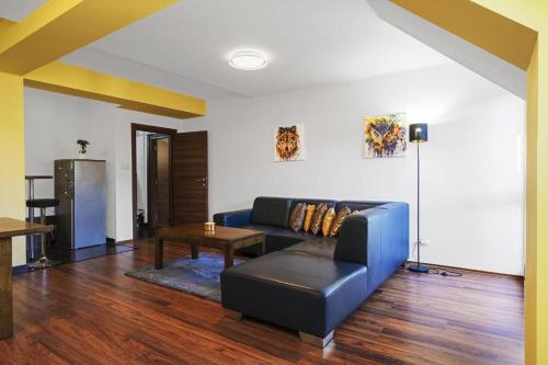 a living room with a blue couch and a table at Apartmán 44 in Donovaly
