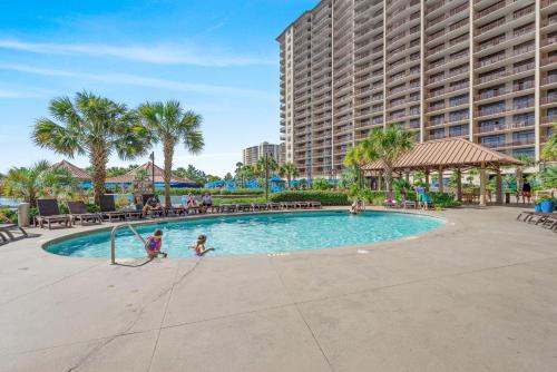 two children playing in a swimming pool at a resort at North Beach Resort and Villas #1916 - Oceanfront in Myrtle Beach